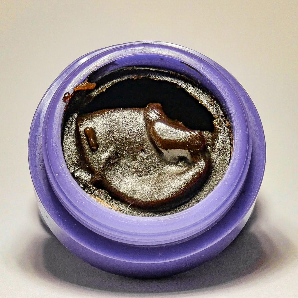 BHO, or Butane Hash Oil in a purple silicon jar.